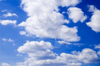 White cumulus clouds against the blue sky