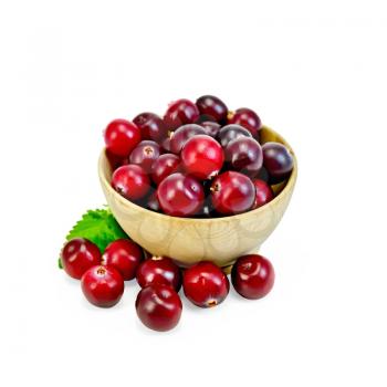 Cranberries in a wooden bowl, mint isolated on white background
