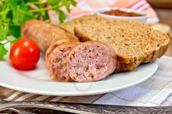 Pork sausages grilled in a plate, bread, sauce, tomato, parsley, napkin on the background of wooden boards