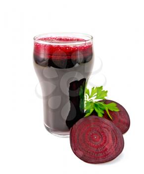 Beet juice in a tall glass, cut into slices with a sprig of parsley beet isolated on white background