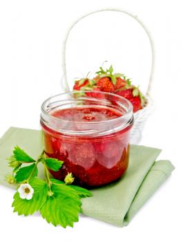 Strawberry jam in a glass jar, strawberries in a white wicker basket on a napkin isolated on white background