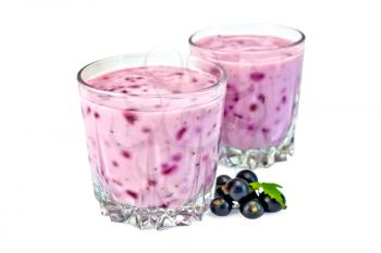 Milkshake in two glass jars, berries and green leaves of black currant isolated on a white background