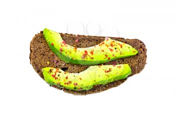 A slice of rye bread with slices of avocado and pepper isolated on white background top