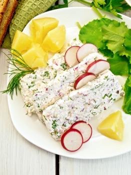 Sliced curd terrine with dill and radishes, green onions, boiled potatoes in a dish, bread, napkin, parsley, lettuce on a light wooden planks on top