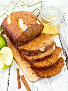 Canadian apple bread with honey and cinnamon, green apple, napkin on the background light wooden boards