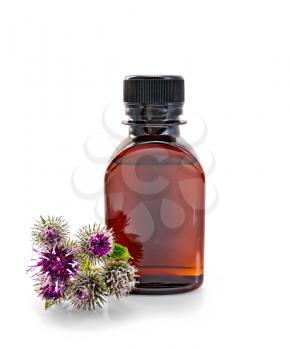 One dark bottle of oil with flowers and leaves of burdock isolated on white background