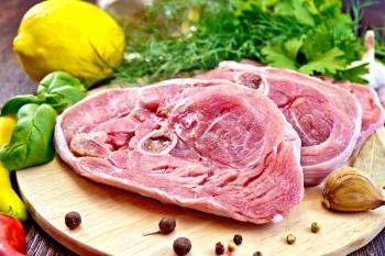 Steak meat raw turkey with pepper, basil, lemon and garlic, vegetable oil on the background of wooden boards