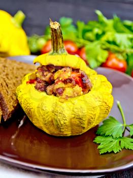 Squash yellow stuffed with meat, tomatoes and peppers, bread in a brown plate, tomatoes, parsley on a dark wooden board