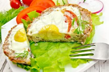 Tartlets meat with egg and tomato cut in the white plate on lettuce, bread and dill on the background wooden boards