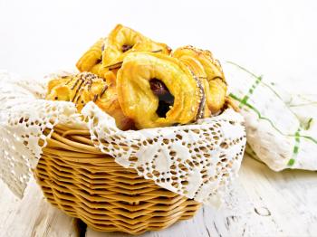 Cookies with dates in a wicker basket with a napkin, towel on a background of wooden boards
