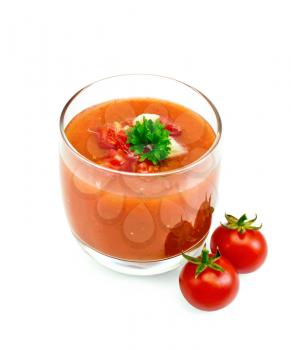 Tomato soup gazpacho in a glass with parsley and vegetables isolated on white background