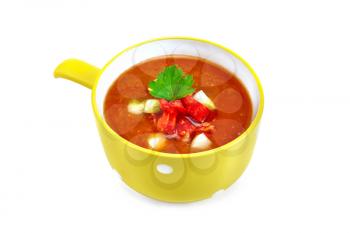 Gazpacho tomato soup in yellow bowl with parsley and vegetables isolated on white background