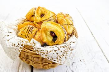 Cookies with dates in a wicker basket with a napkin on a wooden boards background