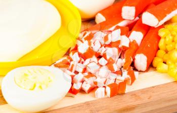 Royalty Free Photo of Sushi, an Egg and Corn on a Cutting Board