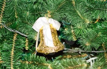 Royalty Free Photo of an Bell Ornament Against Pine Needles