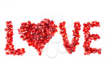 Royalty Free Photo of Pomegranate Berries Spelling the Word Love With a Heart