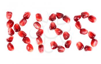 Royalty Free Photo of Pomegranate Seeds Spelling the Word Kiss
