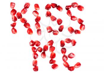 Royalty Free Photo of Pomegranate Berries Spelling the Words Kiss Me