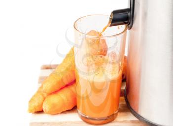 Royalty Free Photo of a Juicer and Carrots