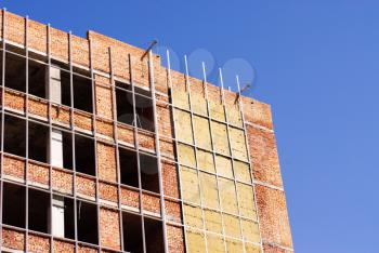 Royalty Free Photo of a Building With Boards on Some Windows
