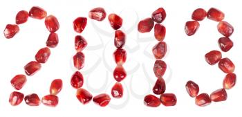 Happy new year 2013. Word of 2013 from the seeds of a pomegranate isolated on white 