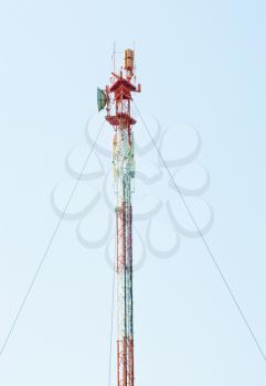 Telecommunications tower with different antenna  on blue sky background  