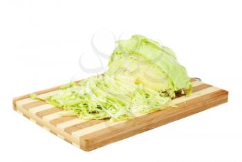 Green cabbage sliced on cutting board isolated  on  white

