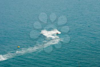 white  trace  water motorcycles on blue sea surface 




