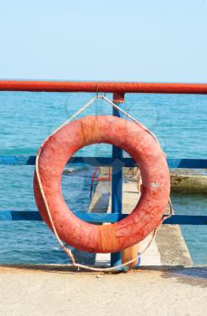Red Lifebuoy in front of the blue sea
