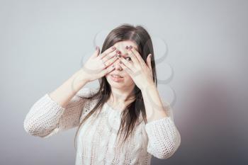 girl covering her eyes with her hands