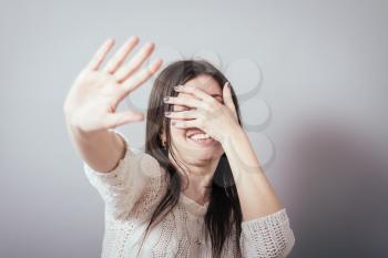 girl covering her eyes with her hands