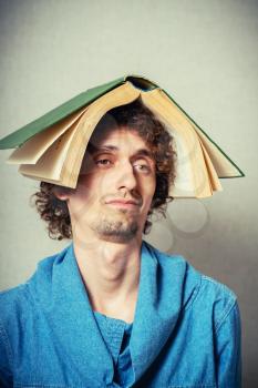 man with a book on his head