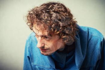 curly-haired man sick and vomits