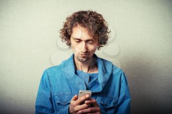 man dials sms, on a white mobile phone