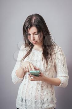 Charming young woman dial SMS to mobile phone