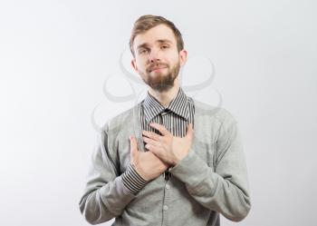 man holding his hand on his chest 
