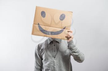 Man with the painted happy smile on the sheet of paper