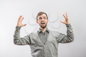 young man is screaming in despair, with hands raised up