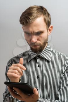 Handsome serious man with tablet computer