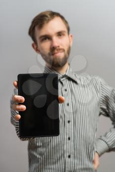 Portrait of a young  man holding his tablet