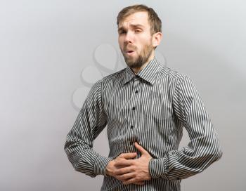 A man suffering in pain in his stomach