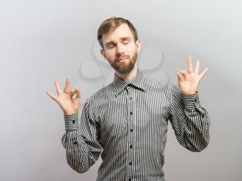 young man shows sign and symbol ok
