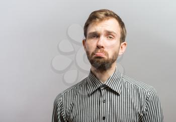 portrait of an offense man over a gray background