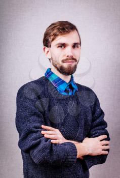 serious young man in blue sweater