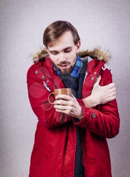 frozen man in red jacket with tea cup