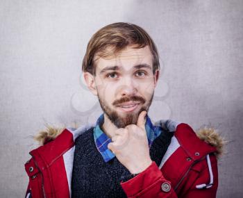 portrait of a young man in a winter red jacket