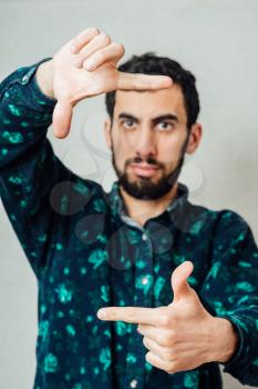 Young hipster man focusing with his fingers