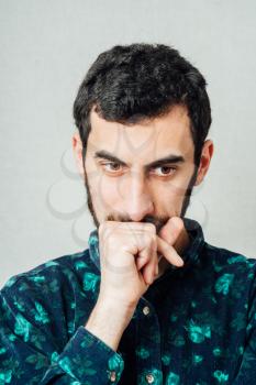 Closeup portrait of young man thinking daydreaming deeply about something with chin on hand fist looking downwards. Emotion facial expressions feelings