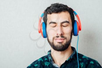 man listens music with headphones
