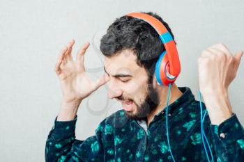 man listens music with headphones